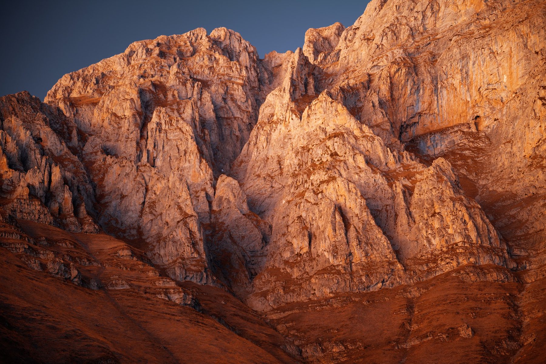 Mount Khustup at golden hour in autumn — warm light on the rock face
