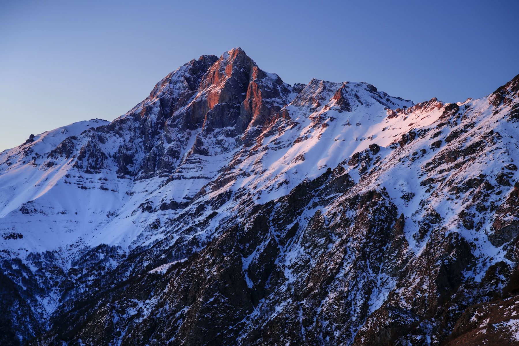 Mount Khustup at dawn in winter — alpenglow on snow
